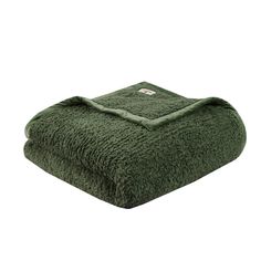 a green towel folded on top of each other