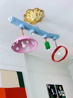 three colorful objects are hanging from the ceiling