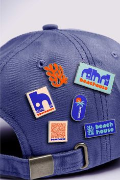 a blue hat with various stickers on the front and back of it's brim