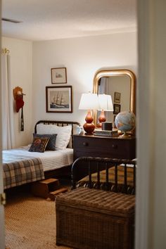 a bedroom with a bed, dresser and mirror in it's centerpieces