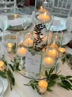 the centerpiece is filled with candles and greenery