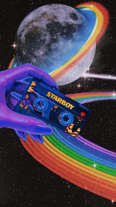 a hand holding an old school cassette in front of a rainbow - colored background and the moon