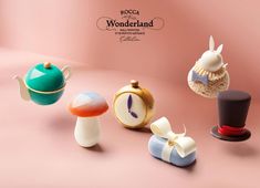 an assortment of miniature items are displayed on a pink background with the word wonderlandland written above them