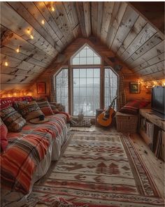 a bedroom with a bed, couch and television in it's attic area that is decorated with string lights