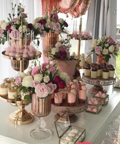 a table topped with lots of cakes and cupcakes