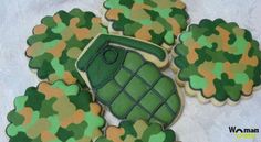 decorated cookies are arranged in the shape of army camouflages with a green house on top