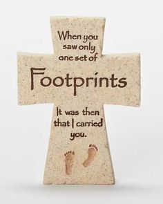 a stone cross with footprints on it that says when you saw only one set of footprints, it was then that i carried you