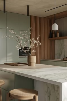 a vase with some flowers sitting on top of a kitchen counter next to two stools