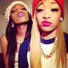 two young women with fake noses and hats on their heads, one is blowing out her tongue