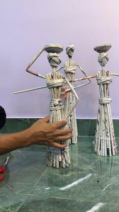 a person is making sculptures out of sticks