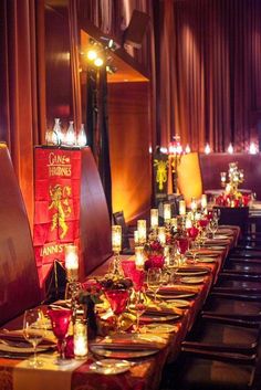 a long table is set up with candles and place settings for the dinner guests to enjoy