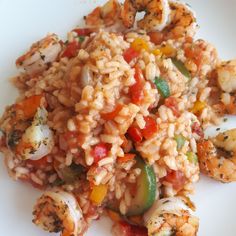 rice with shrimp and vegetables on a white plate