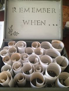 an open box filled with lots of white paper cups on top of a wooden table