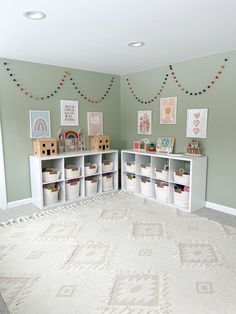 a room with green walls and white shelves filled with crafting supplies on the floor