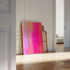 an abstract painting is displayed in the middle of a room with white walls and parquet flooring