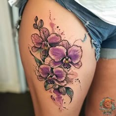 a woman's thigh with purple flowers on it