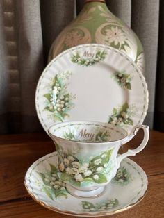 a cup and saucer sitting on top of a wooden table