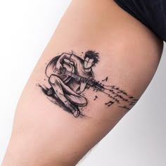 a man with a guitar tattoo on his arm