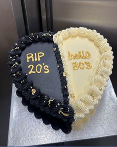 two heart shaped cakes decorated with black and white frosting, the words rip 20's written on them