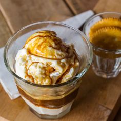 an ice cream sundae with waffles and caramel sauce on a wooden tray