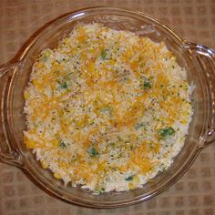 a casserole dish with cheese and broccoli in it on a table