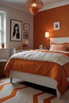 an orange and white bedroom with pictures on the wall