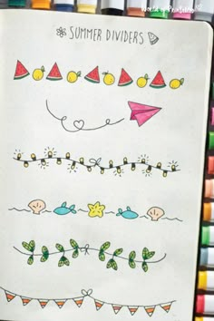 an open notebook with some drawings and markers on the pages, along with crayons