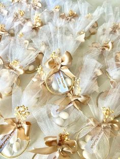 wedding garters with gold and white bows on them are displayed in this photo