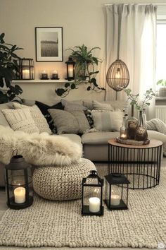 a living room filled with lots of furniture and candles on top of the rugs