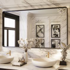 a bathroom with two sinks and a large mirror in it's centerpieces