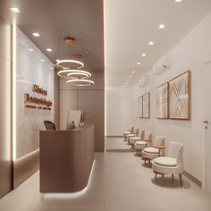 an empty waiting room with white chairs and lights on the wall, along with a reception counter