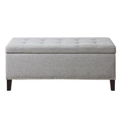 a gray bench with buttons on the top and bottom, in front of a white background