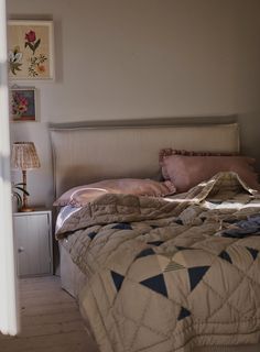 a bed sitting in a bedroom next to a window