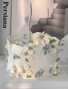 a white cake with blue and white flowers on it