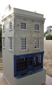 a model house sitting on top of a cement block