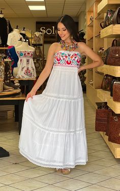 This Beautiful Strapless Dress boasts a Traditional Mexican floral design combined with a modern style dress. The corrugated skirt combined with the strapless embroidered top makes it fun and flirty. It's made out of fine Mexican corrugated cotton and has elastic on the back for a tighter fit. It has lace details throughout. This dress is handmade and completely hand embroidered by Mexican Artisans in Puebla, Mexico. More available dresses here: https://www.etsy.com/es/shop/SoleiEthnic?ref=selle Mexican Wedding Dress Guest, Bohemian Sleeveless Dress With Embroidered Hem, Bohemian Sleeveless Embroidered Dress, White Summer Fiesta Dress, Bohemian Embroidered Sleeveless Fitted Dress, White Sleeveless Bohemian Embroidered Dress, Sleeveless Bohemian Embroidered Dress, White Bohemian Sleeveless Embroidered Dress, Folk Style Sleeveless Embroidered Festival Dress