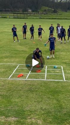 a group of men standing on top of a field next to each other in front of a frisbee