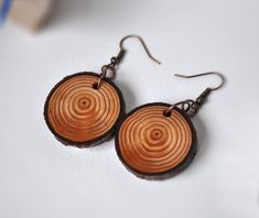 wooden earrings with spiral designs on them