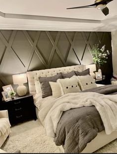 a bedroom with a bed, nightstand and ceiling fan