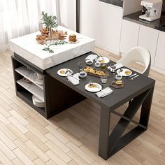 a dining table with plates and cups on it in front of a kitchen counter top