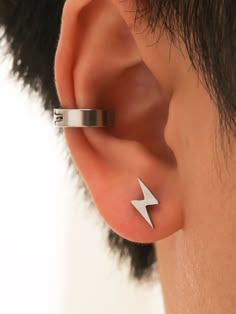 a person wearing an ear cuff with a lightning bolt on it