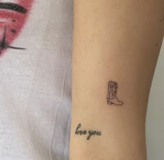 a woman's arm with a small tattoo on it that says love your boot