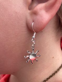 This exquisite pair of silver earrings celebrates the radiant beauty of the sun with a unique design that captivates and charms. Each earring features a meticulously crafted sun charm, distinguished by its detailed rays that extend outward. The earrings boast a polished finish that enhances the intricate detailing of the sun's rays and the sleekness of the design. The choice of silver as the material not only ensures durability and a timeless appeal but also gives the earrings a luminous quality Sun Earring, Radiant Beauty, Sun Charm, Best Gifts For Her, Great Gifts For Mom, Charm Set, Charm Gift, Gift For Mom, Jewelry Earrings Dangle