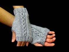 two hands holding each other while wearing knitted gloves