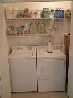 a washer and dryer sitting in a small room next to eachother