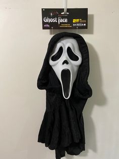 a ghost face mask hanging on the wall