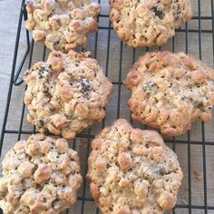 four cookies are cooling on a wire rack