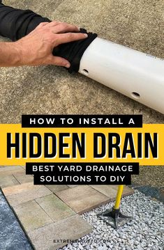 a man is installing a hidden drain in the ground with his hand on top of it