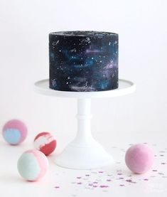 an image of a cake with stars on it and some balls in the foreground