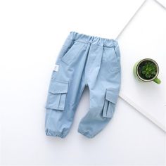 Boys Solid Pocket Casual Pants - PrettyKid Non-stretch Solid Color Cotton Cargo Pants, Non-stretch Cotton Cargo Pants In Solid Color, Baggy Ankle-length Denim Blue Pants, Non-stretch Solid Cotton Cargo Pants, Denim Blue Ankle-length Bottoms With Pockets, Blue Cotton Solid Color Pants, Blue Cotton Pants For Fall, Solid Color Cotton Trousers, Solid Blue Cotton Pants